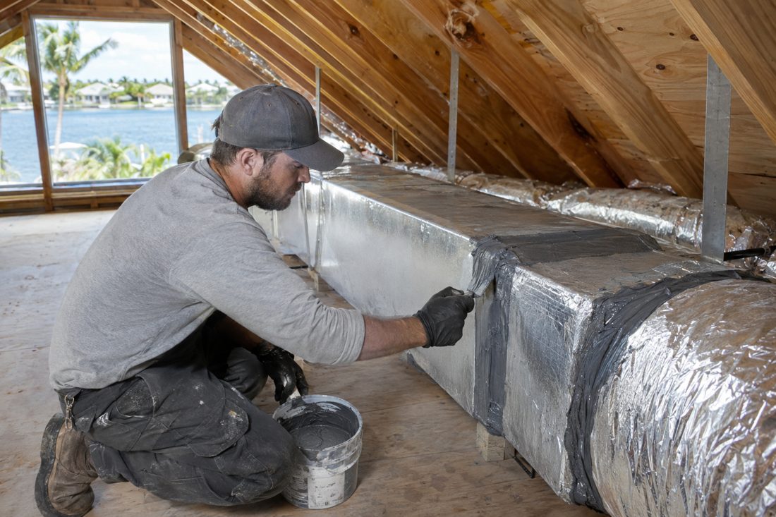 Ductwork being sealed with mastic in an attic at a waterfront ranch home in North Palm Beach, FL
